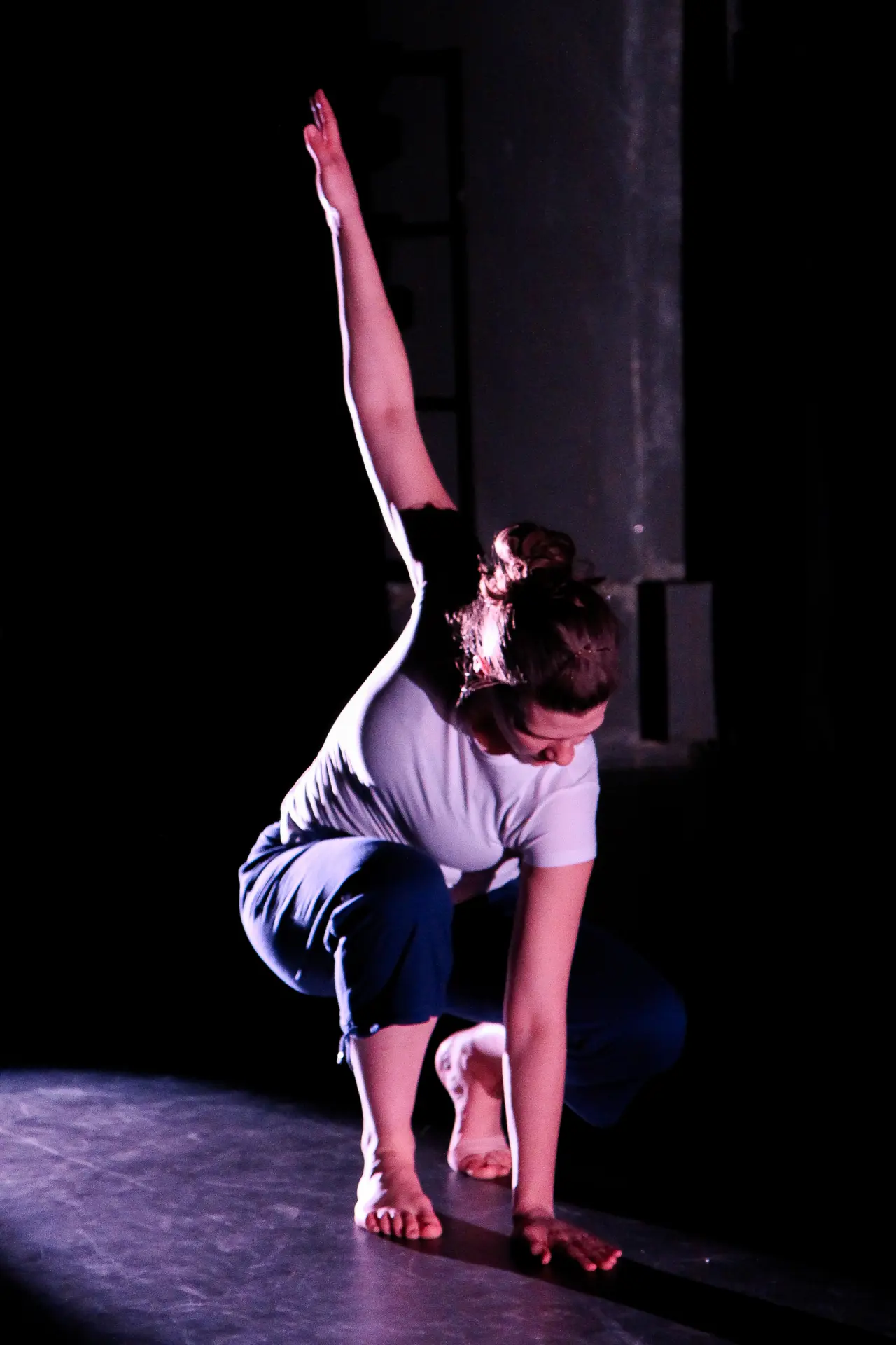 Dancer mid-movement on stage in Lead The Way, a dance performance by True Motion Dance at the Green Room in Manchester. Side lit with warm lighting. Captured by Dance photography specialist, Fourth Wall Photography.