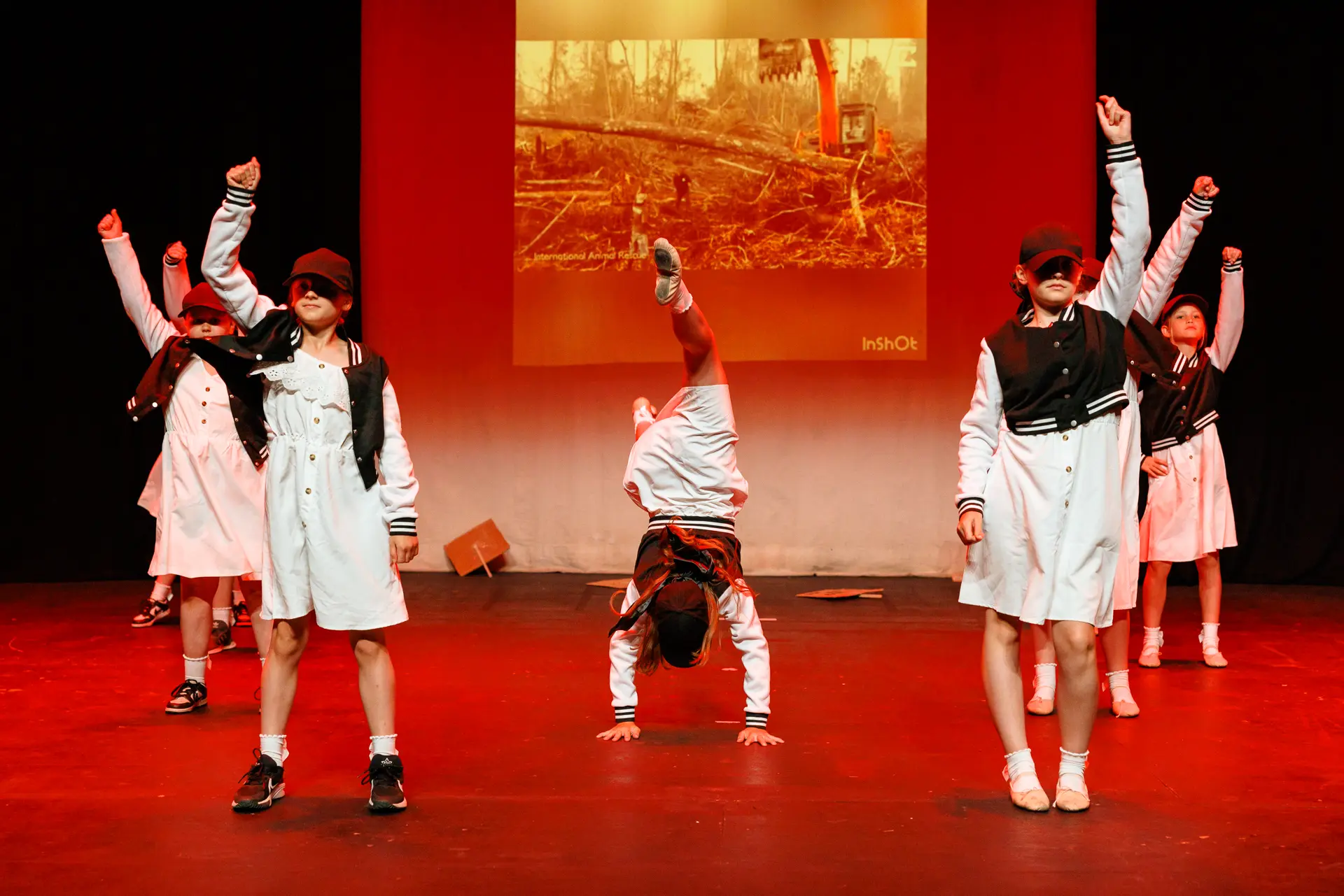 Young dancers performing a street dance routine at the Schools Dance Festival at the Marina Theatre Lowestoft. Captured mid‑movement on stage with vibrant lighting. Captured by Dance photography specialist, Fourth Wall Photography.