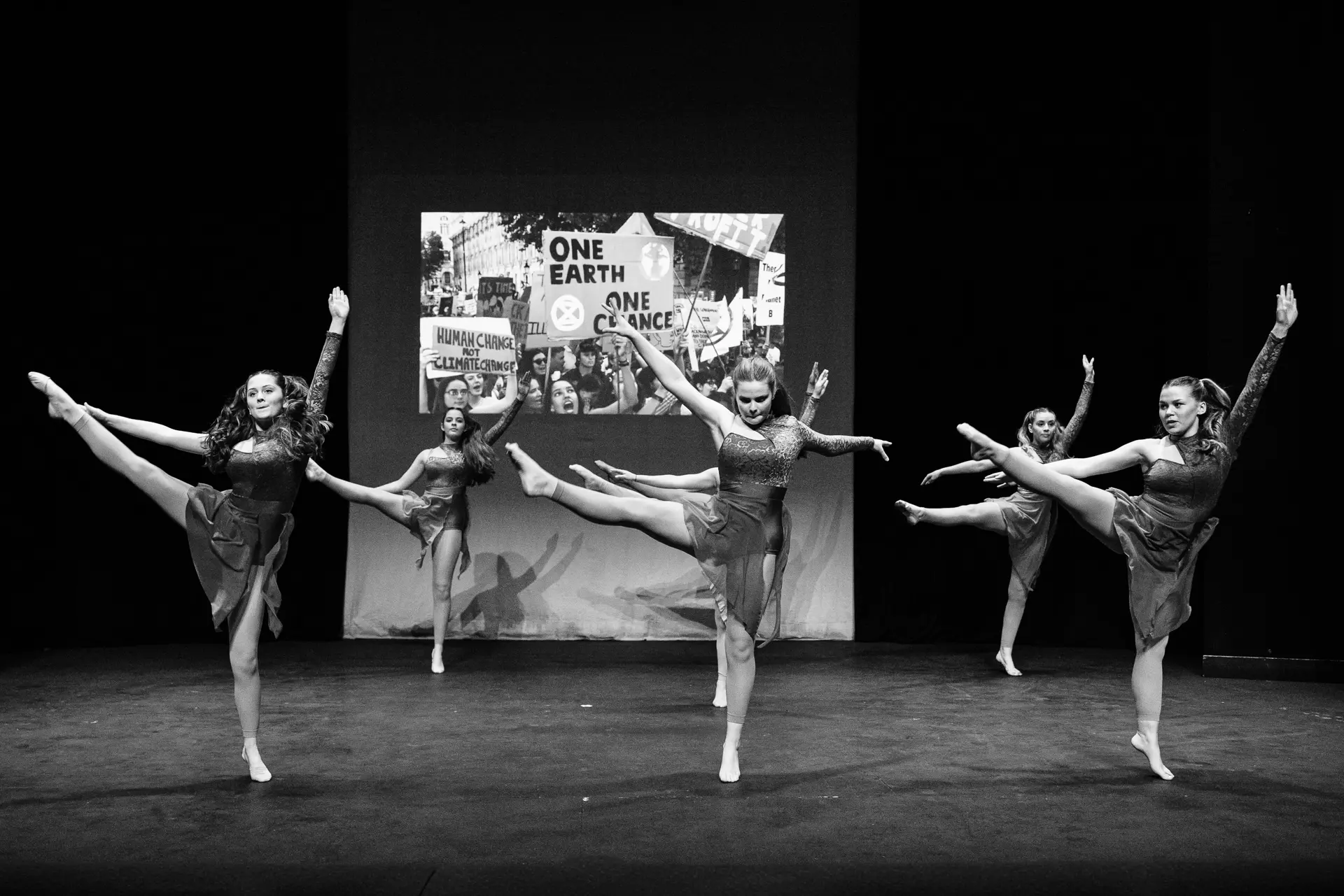 Young dancers performing a contemporary dance routine at the Schools Dance Festival at the Marina Theatre Lowestoft. Captured mid‑movement on stage with vibrant lighting. Captured by Dance photography specialist, Fourth Wall Photography.