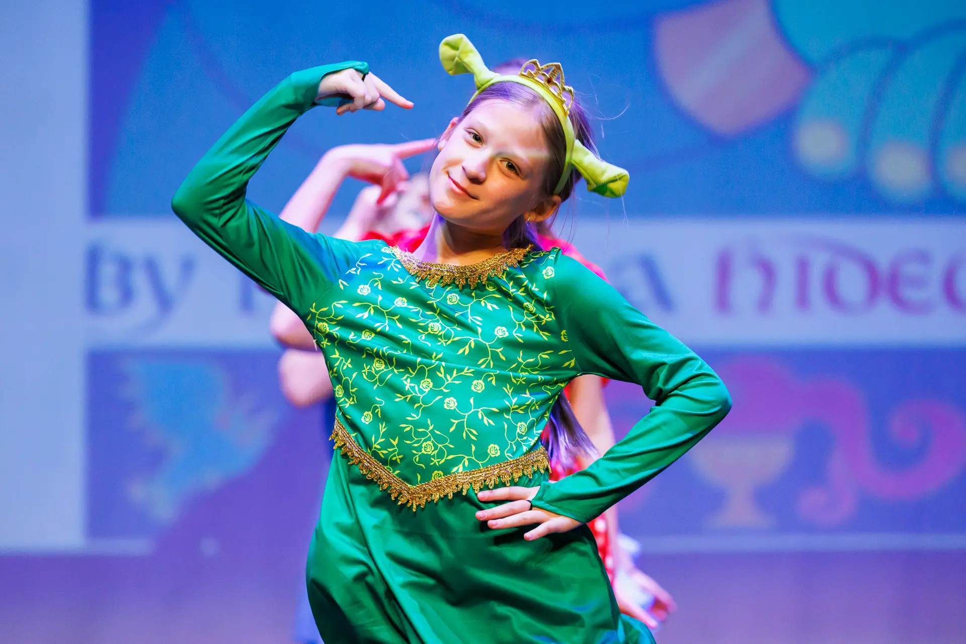 Young dancers performing a musical theatre routine at the Schools Dance Festival at the Marina Theatre Lowestoft. Captured mid‑movement on stage with vibrant lighting. Captured by Dance photography specialist, Fourth Wall Photography.