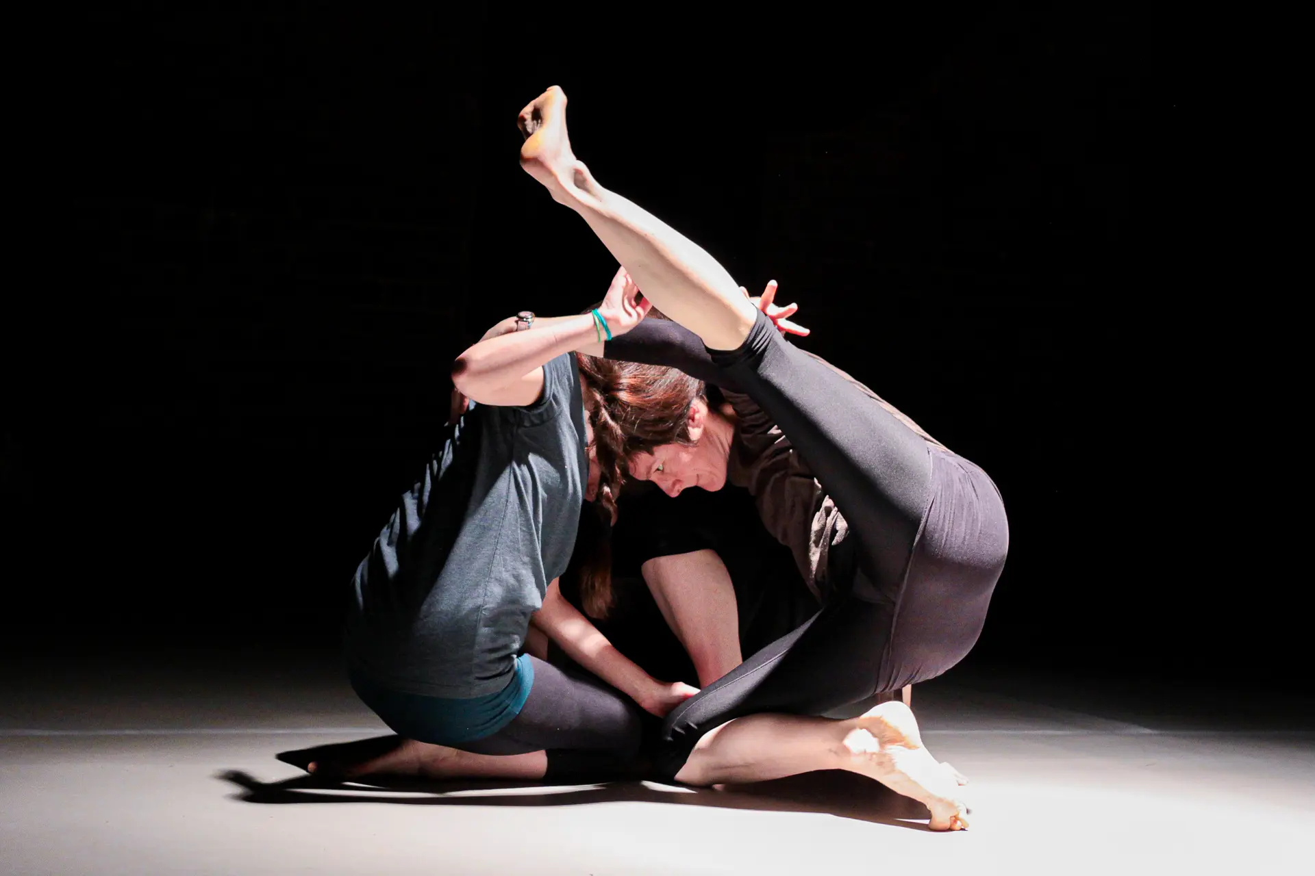 Dancers performing a contemporary dance routine on stage at The Cut Arts Centre in Halesworth, Suffolk, during a dynamic dance showcase, captured with vibrant lighting and expressive movement. Captured by Dance photography specialist, Fourth Wall Photography.