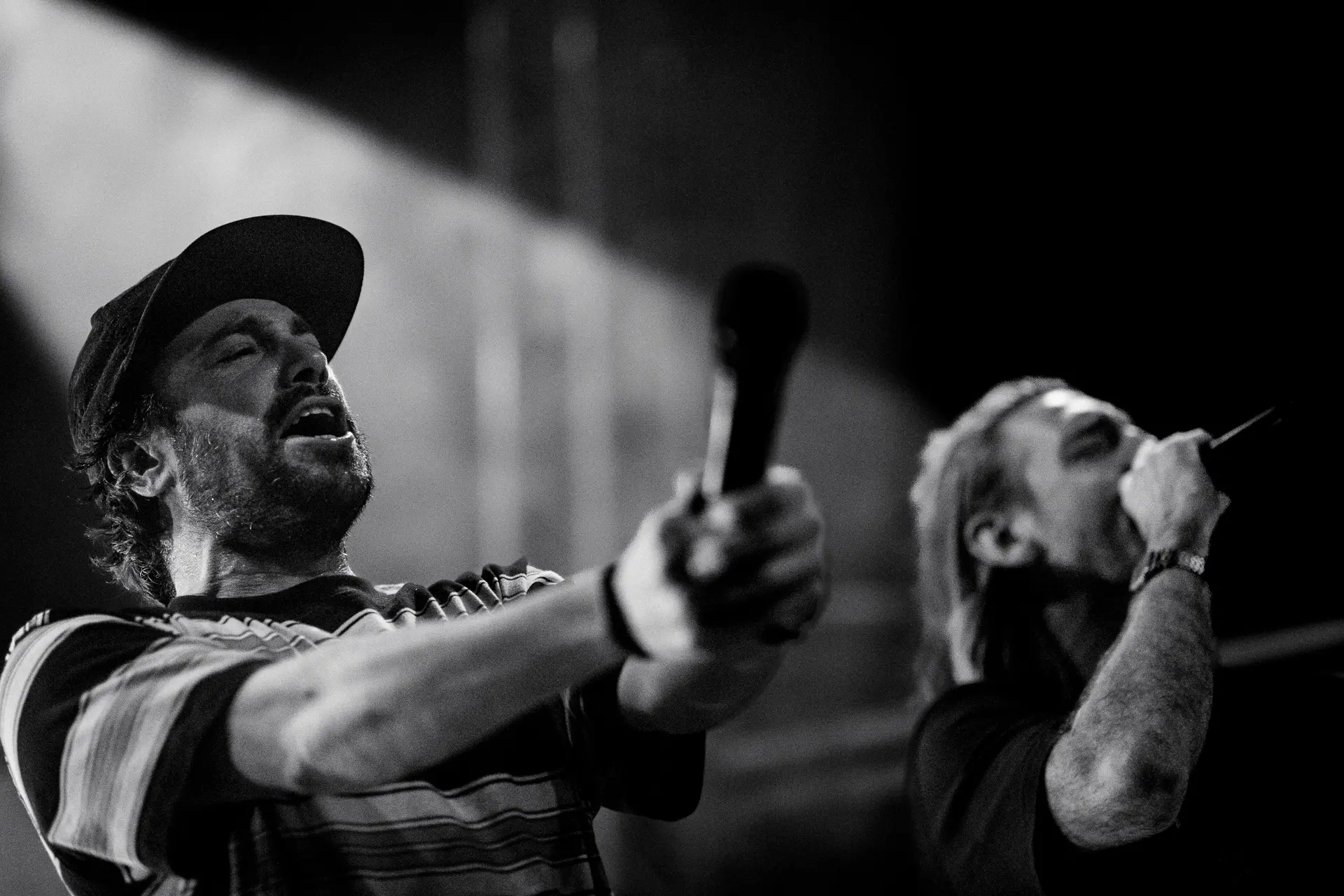 Rap duo Too Many T's performing live on stage at Norwich Arts Centre, rapping into microphones under stage lights and smoke. Captured by Live Music photography specialist, Fourth Wall Photography.