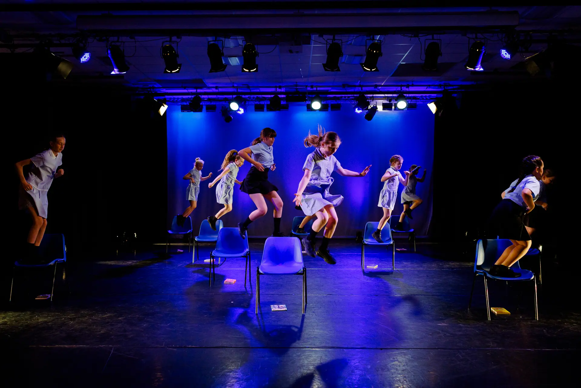 Dancer performing a musical theatre dance routine on stage at the True Motion Dance Showcase at the Atrium Theatre in Norfolk, captured mid‑movement with expressive choreography and dynamic lighting. Captured by Dance photography specialist, Fourth Wall Photography.