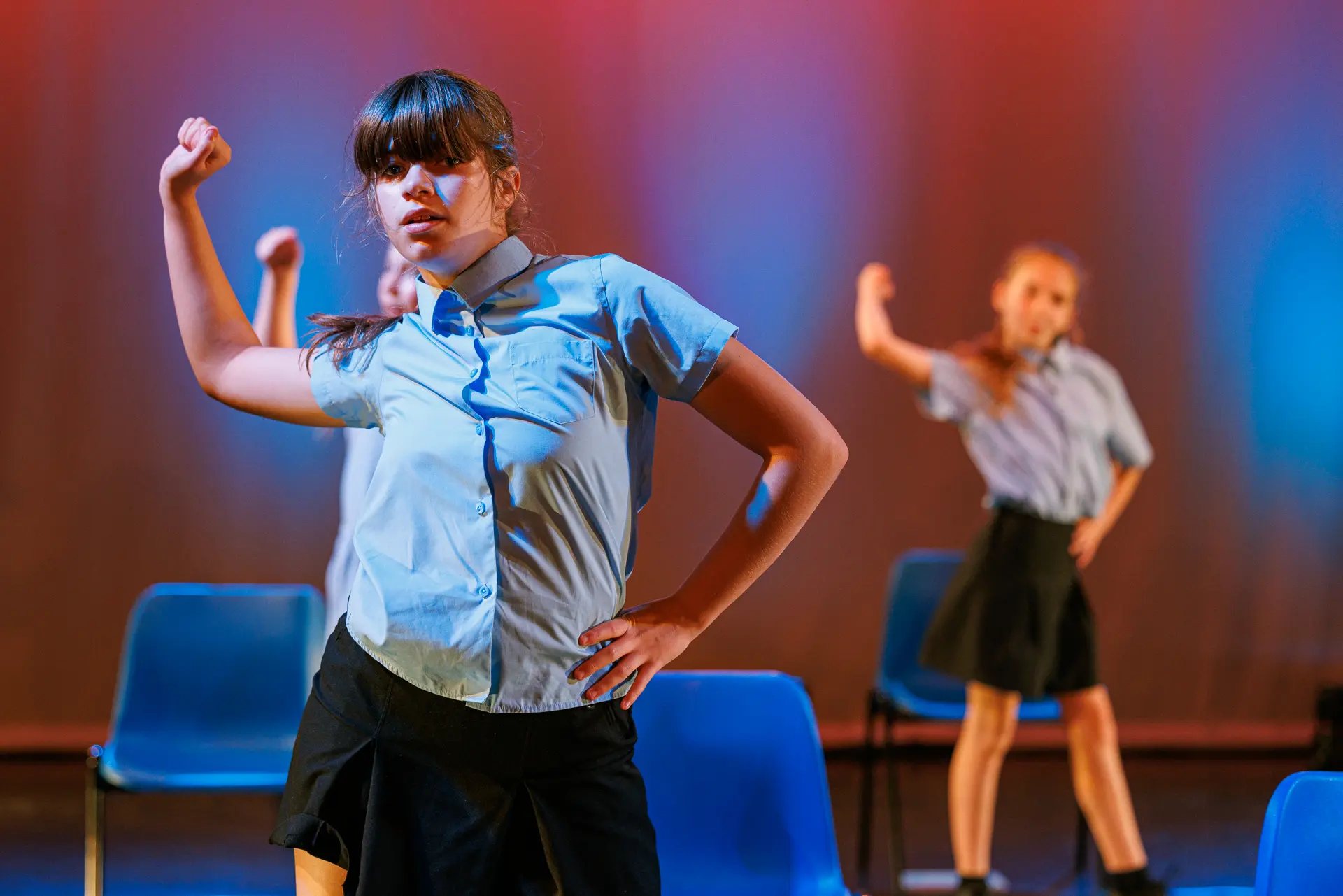Dancers performing a musical theatre dance routine on stage at the True Motion Dance Showcase at the Atrium Theatre in Norfolk, captured mid‑movement with expressive choreography and dynamic lighting. Captured by Dance photography specialist, Fourth Wall Photography.