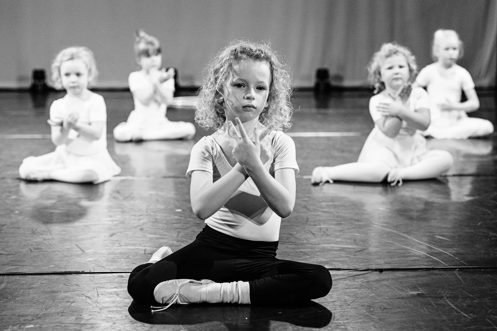 Dancers performing a ballet dance routine on stage at the True Motion Dance Showcase at the Atrium Theatre in Norfolk, captured mid‑movement with expressive choreography and dynamic lighting. Captured by Dance photography specialist, Fourth Wall Photography.