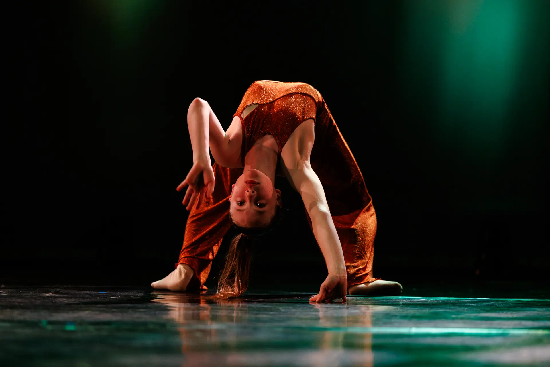 Dancer performing a contemporary dance routine on stage at the True Motion Dance Showcase at the Atrium Theatre in Norfolk, captured mid‑movement with expressive choreography and dynamic lighting. Captured by Dance photography specialist, Fourth Wall Photography.